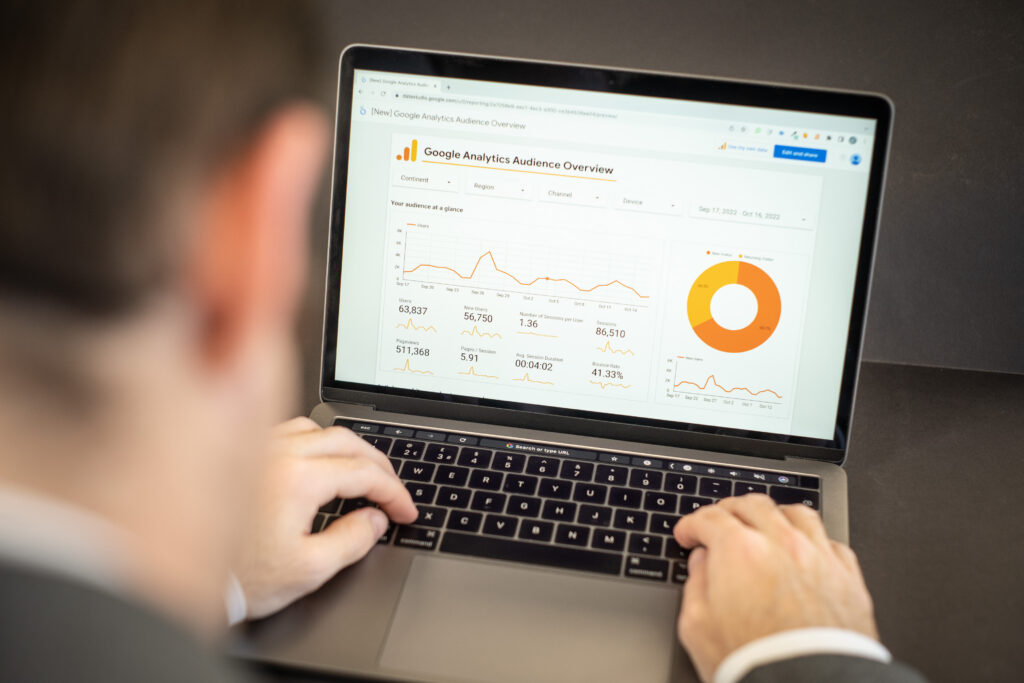 Laptop displaying website analytics during a website migration planning review